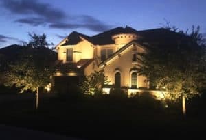 A home is visible at night thanks to outdoor lighting