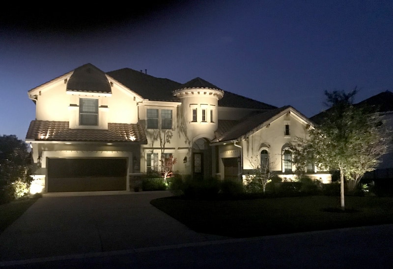 A home's exterior enhanced by well designed outdoor lighting