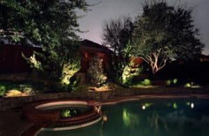 A swimming pool is professionally lit up at night