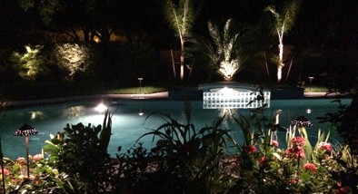 Lighting around a pool at night beautifies the scene