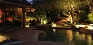 Dramatic lighting sets the mood around a pool