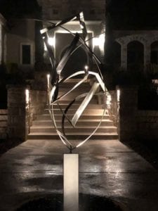 Image of a metal sculpture being lit with outdoor led lighting