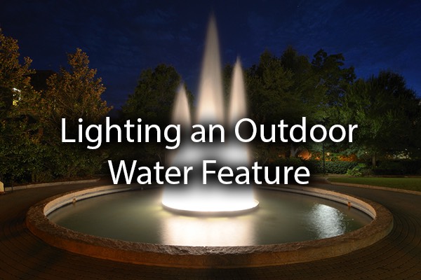 A gorgeous fountain with the words, lighting an outdoor water feature.