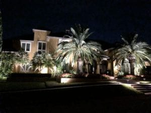 A beautiful shot of a front of a home with immaculate outdoor lighting.