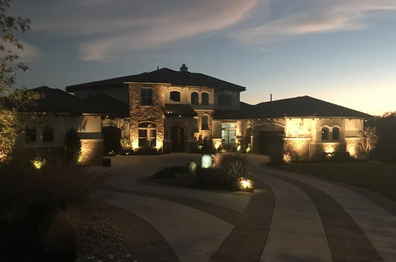 beautiful front yard lit up with lights