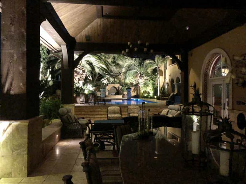 outdoor lighting around a pool and under patio