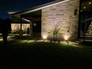 security lighting lights up pathway to the front door of a home