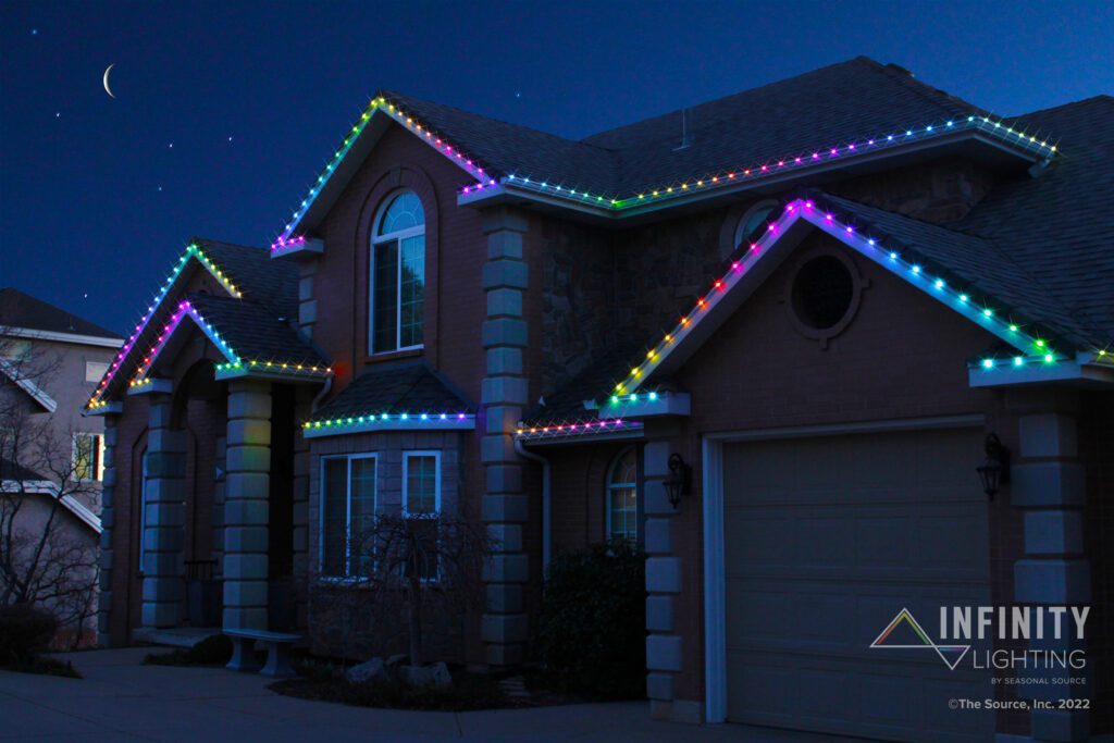 Rainbow Colored Infinity Lights on a Brick Home.