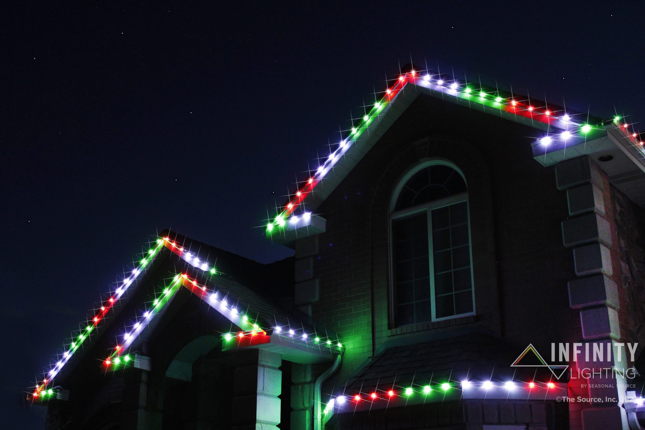 Permanent Christmas lights installed on the roof line of a house.