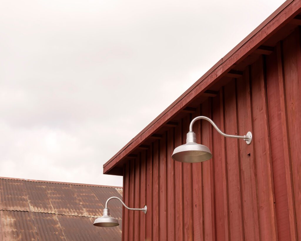 Gooseneck lights on wood barn wall